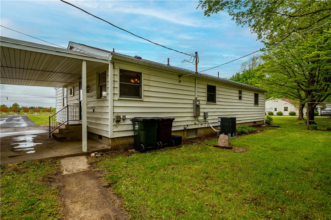 11296 Pansing Road Brookville, OH 45309 - Photo 38 of 53 This home offers a practical side entrance with a covered porch and expansive yard.