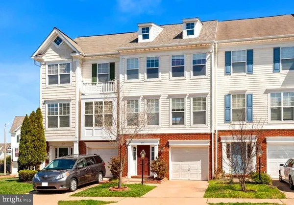 a front view of a residential apartment building with a yard