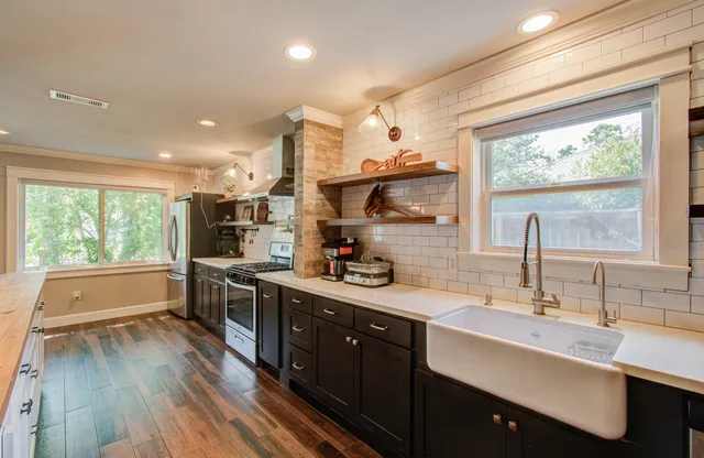 a kitchen with a sink stove and wooden cabinets