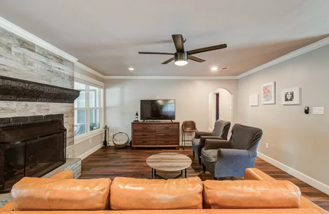 a living room with furniture and a fireplace