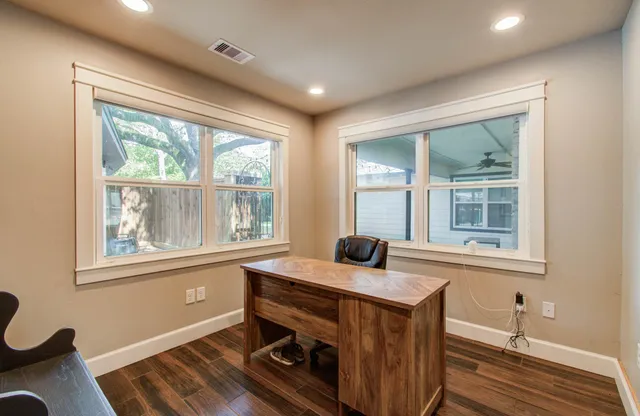 a room with wooden floor and furniture