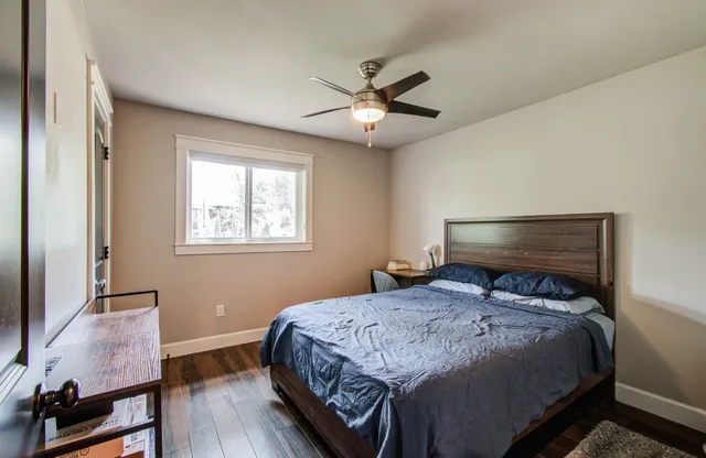 a bedroom with a bed and a window