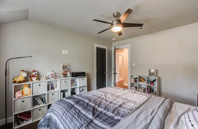 a bedroom with a bed and a chandelier