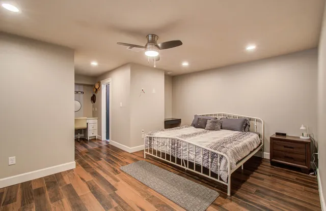 a bedroom with a bed and a ceiling fan