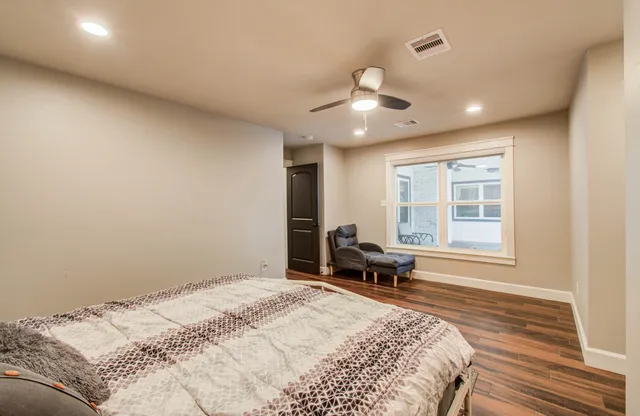 a bedroom with a bed and a large window