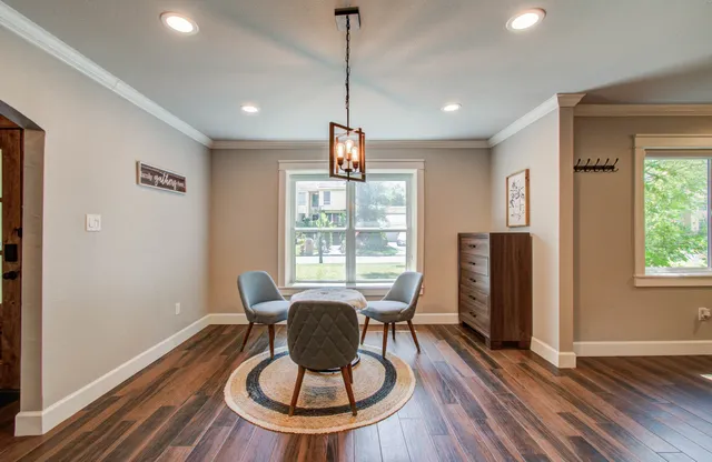 a view of a dining room with furniture window and wooden floor