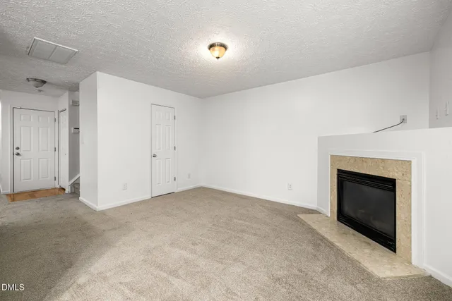 an empty room with fireplace