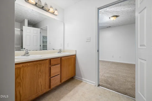 a bathroom with a double vanity sink and mirror