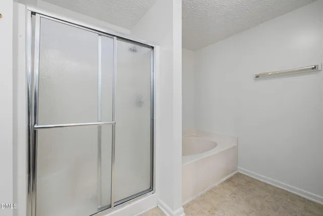 a bathroom with a bathtub and shower