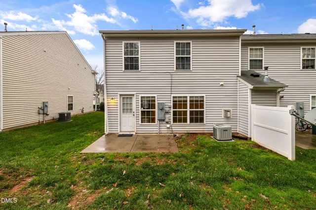 a view of a backyard with plants and large tree