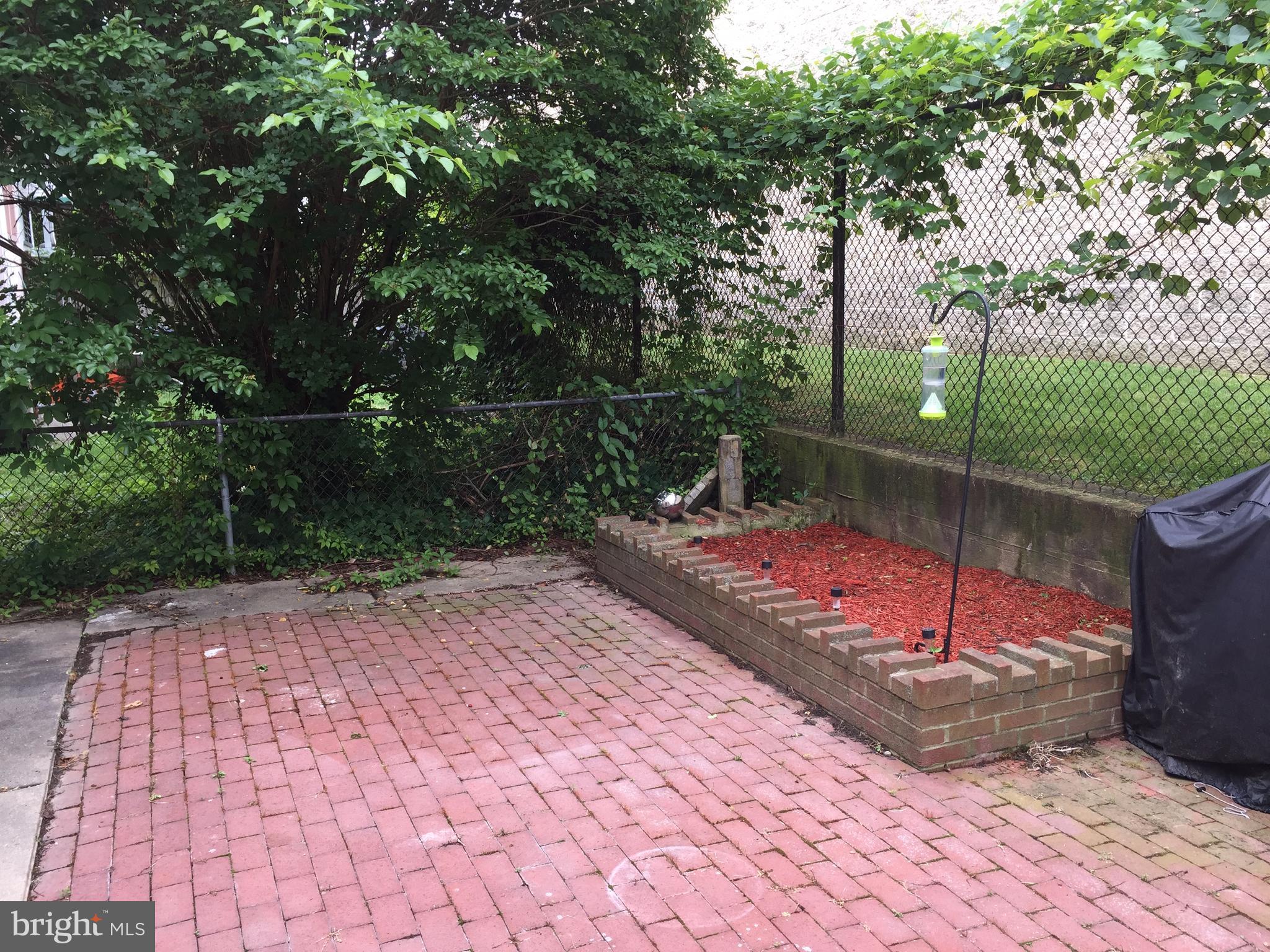 3019 Beverly Road Baltimore, MD 21214 - Photo 12 of 14 Paver patio with flowerbed/herb garden