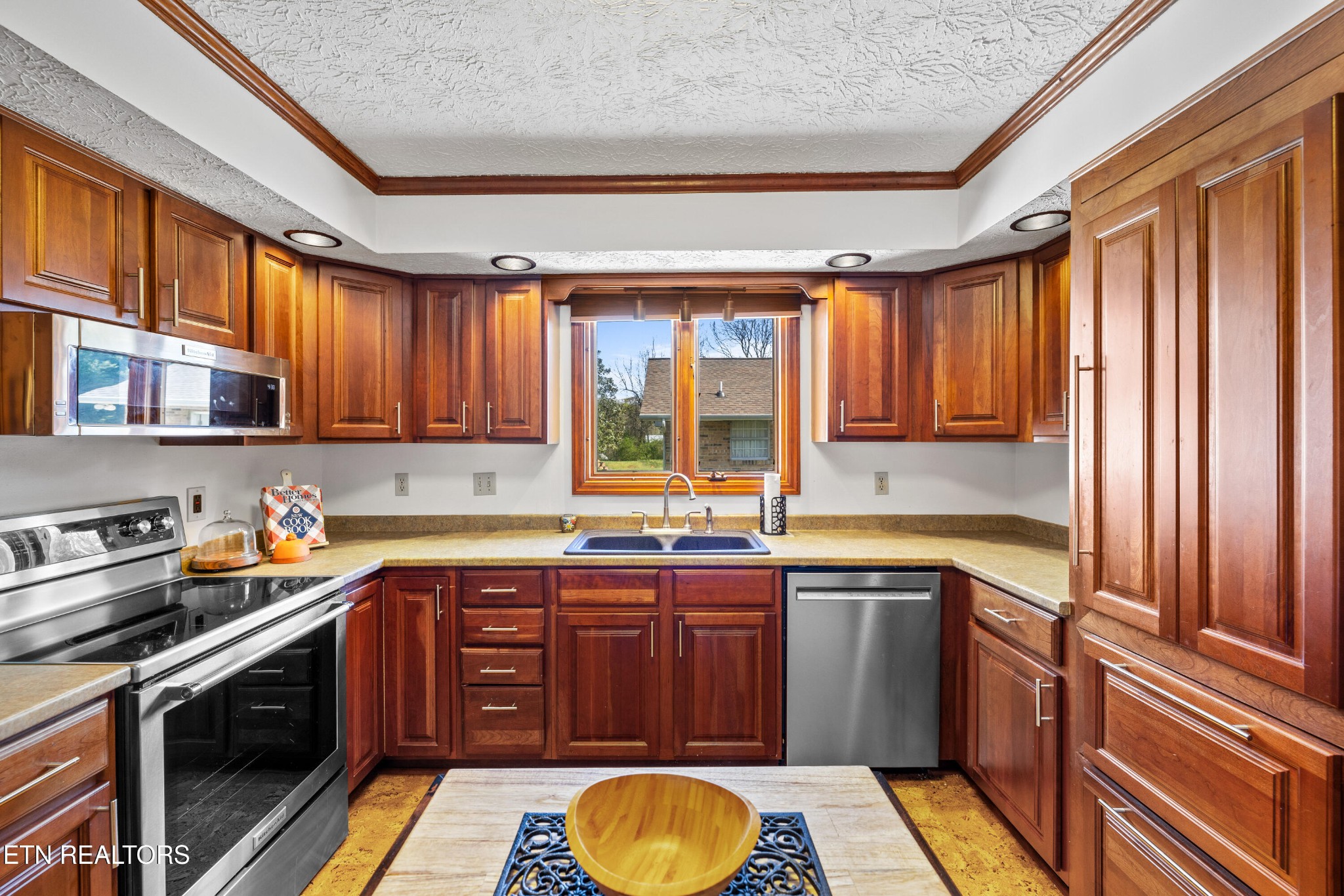 3941 Simpson Road Lenoir City, TN 37772 - Photo 12 of 35 a kitchen with stainless steel appliances granite countertop a sink stove and cabinets