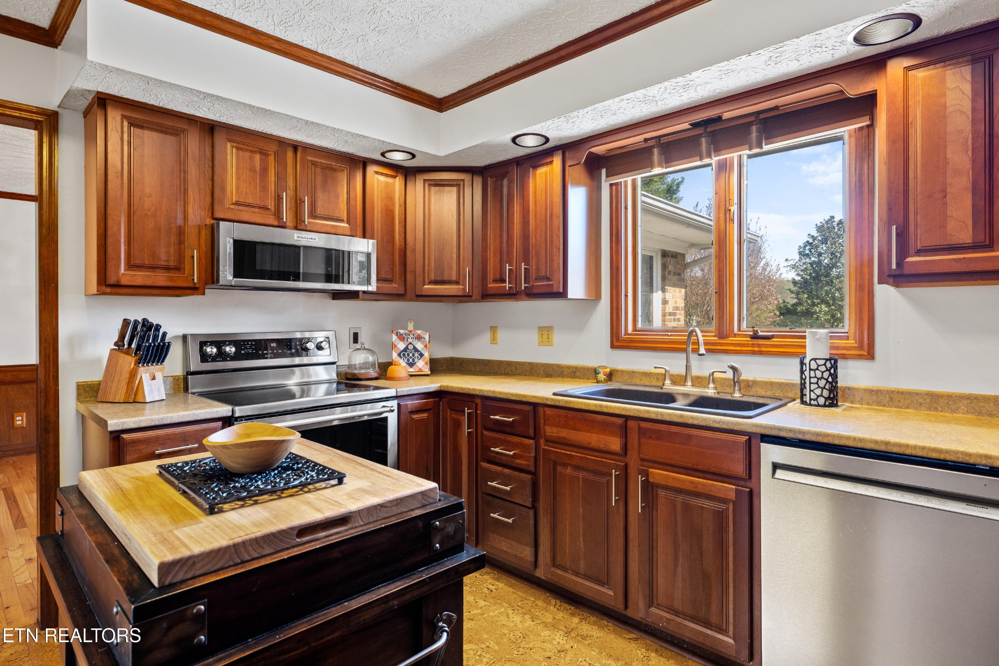 3941 Simpson Road Lenoir City, TN 37772 - Photo 13 of 35 a kitchen with stainless steel appliances a stove sink microwave and window