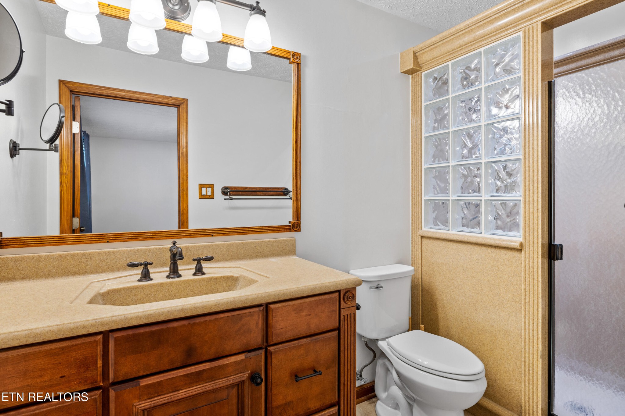 3941 Simpson Road Lenoir City, TN 37772 - Photo 20 of 35 a bathroom with a sink a toilet and a mirror