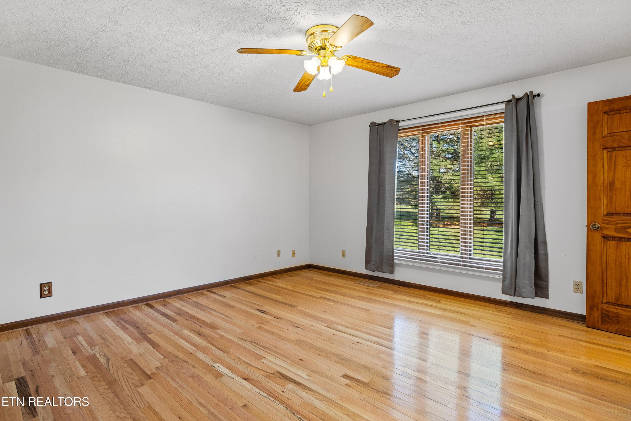 3941 Simpson Road Lenoir City, TN 37772 - Photo 21 of 35 a view of empty room with wooden floor and fan