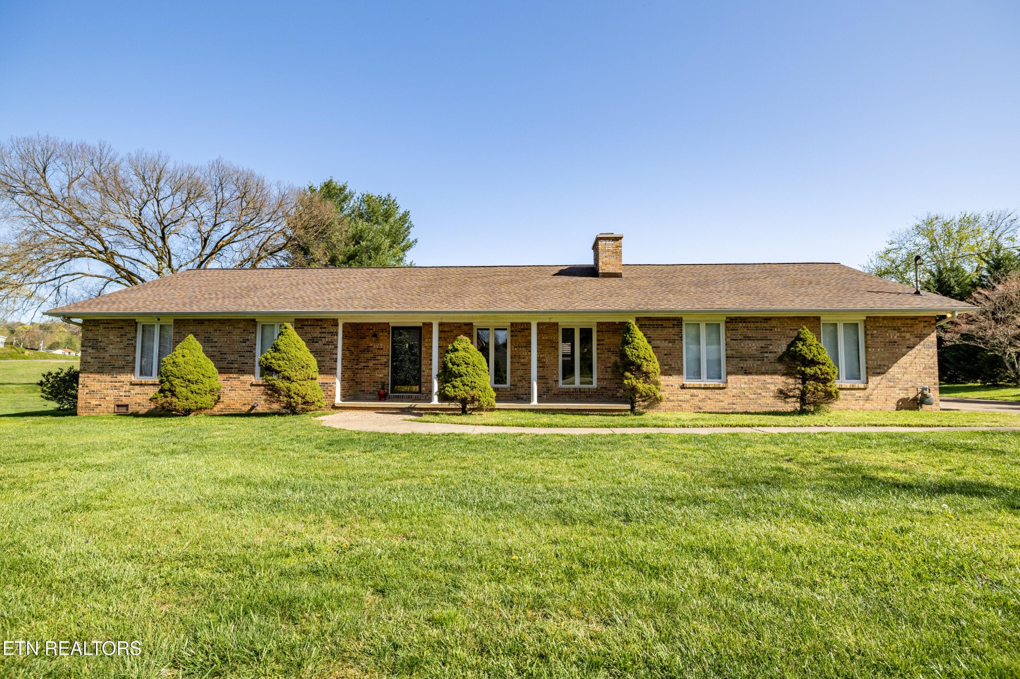 3941 Simpson Road Lenoir City, TN 37772 - Photo 3 of 35 a front view of a house with a garden and porch