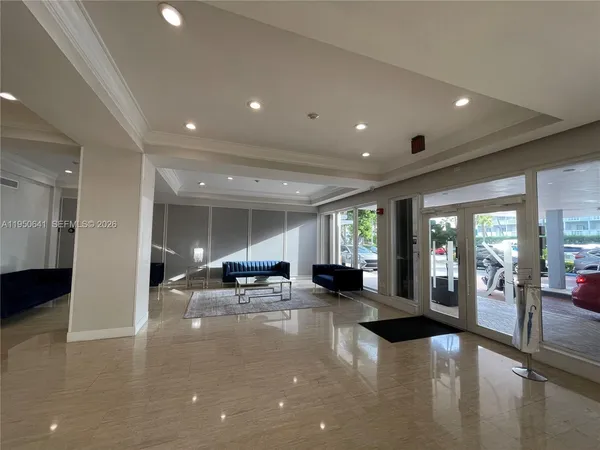 a lobby with furniture and large windows