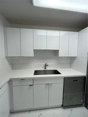 a kitchen with a sink stove and microwave