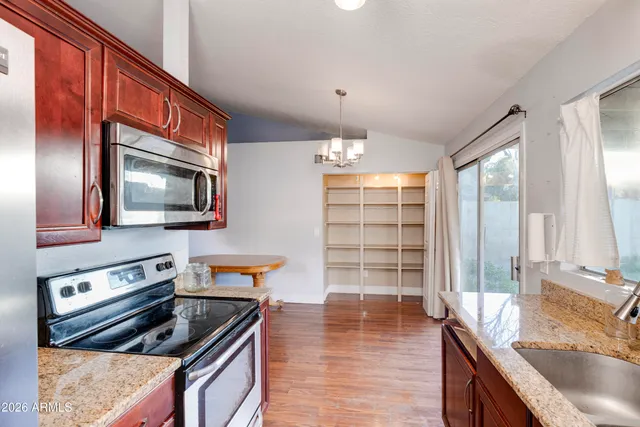 a kitchen that has a sink and a stove in it