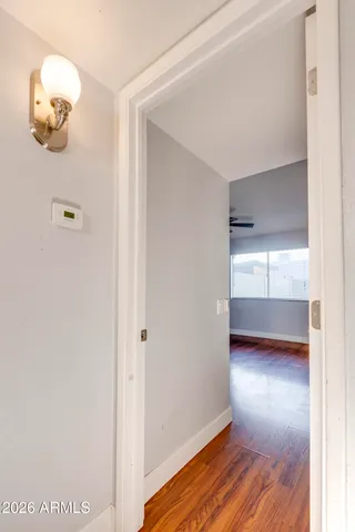 a view of empty room with wooden floor
