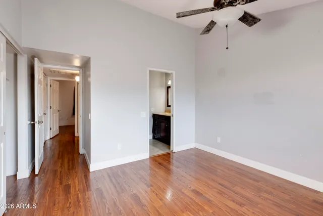 a view of a room with wooden floor and entryway