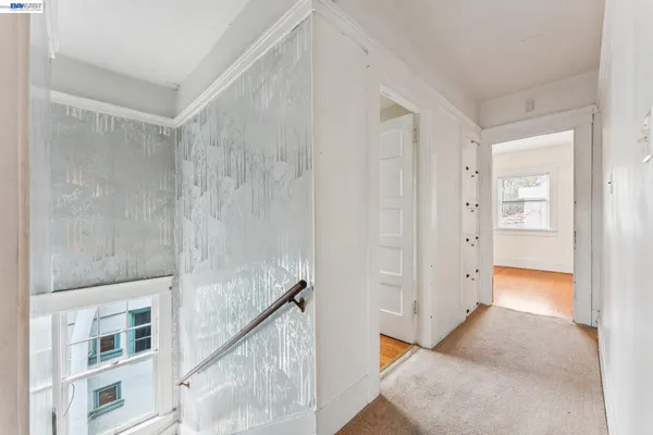 a view of an empty room and wooden floor