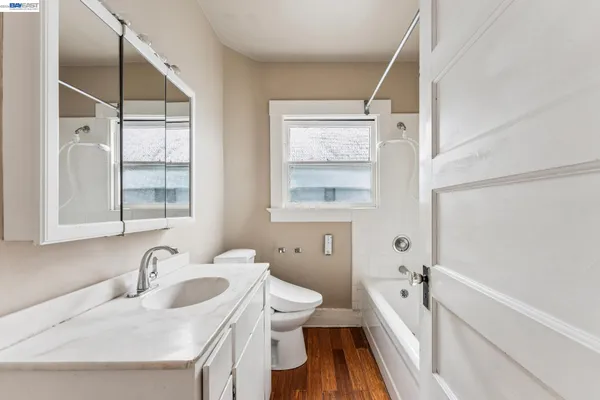 a bathroom with a sink toilet and mirror
