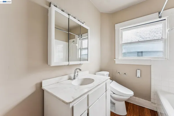 a bathroom with a bathtub shower and toilet