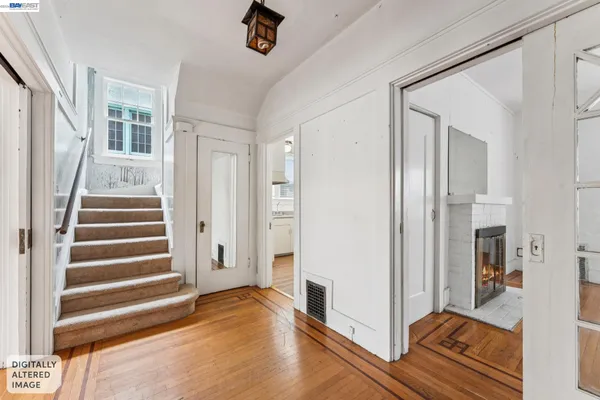 a view of entryway with wooden floor and stairs