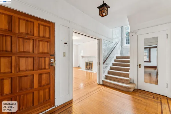 a view of entryway and hall with wooden floor