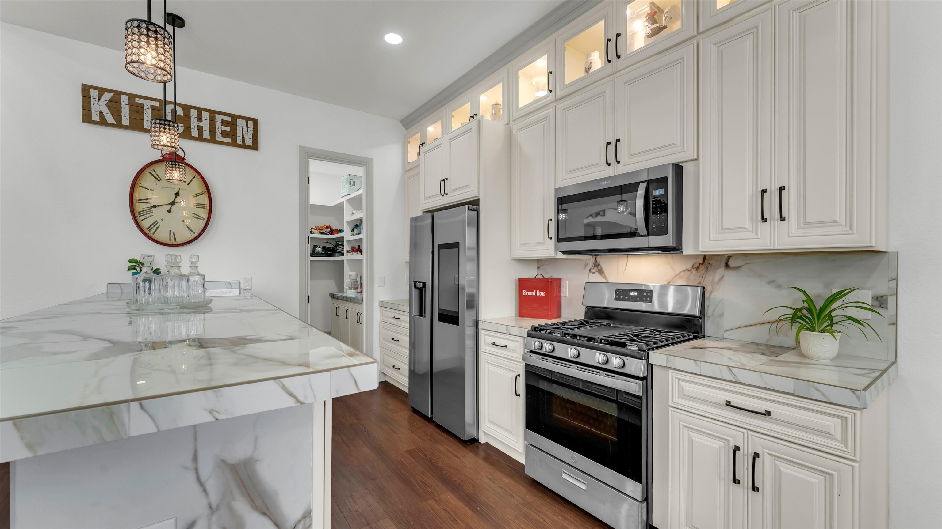 292 Oak Ridge Trail Kingsland, TX 78639 - Photo 13 of 29 a kitchen with stainless steel appliances granite countertop a stove a microwave and a refrigerator