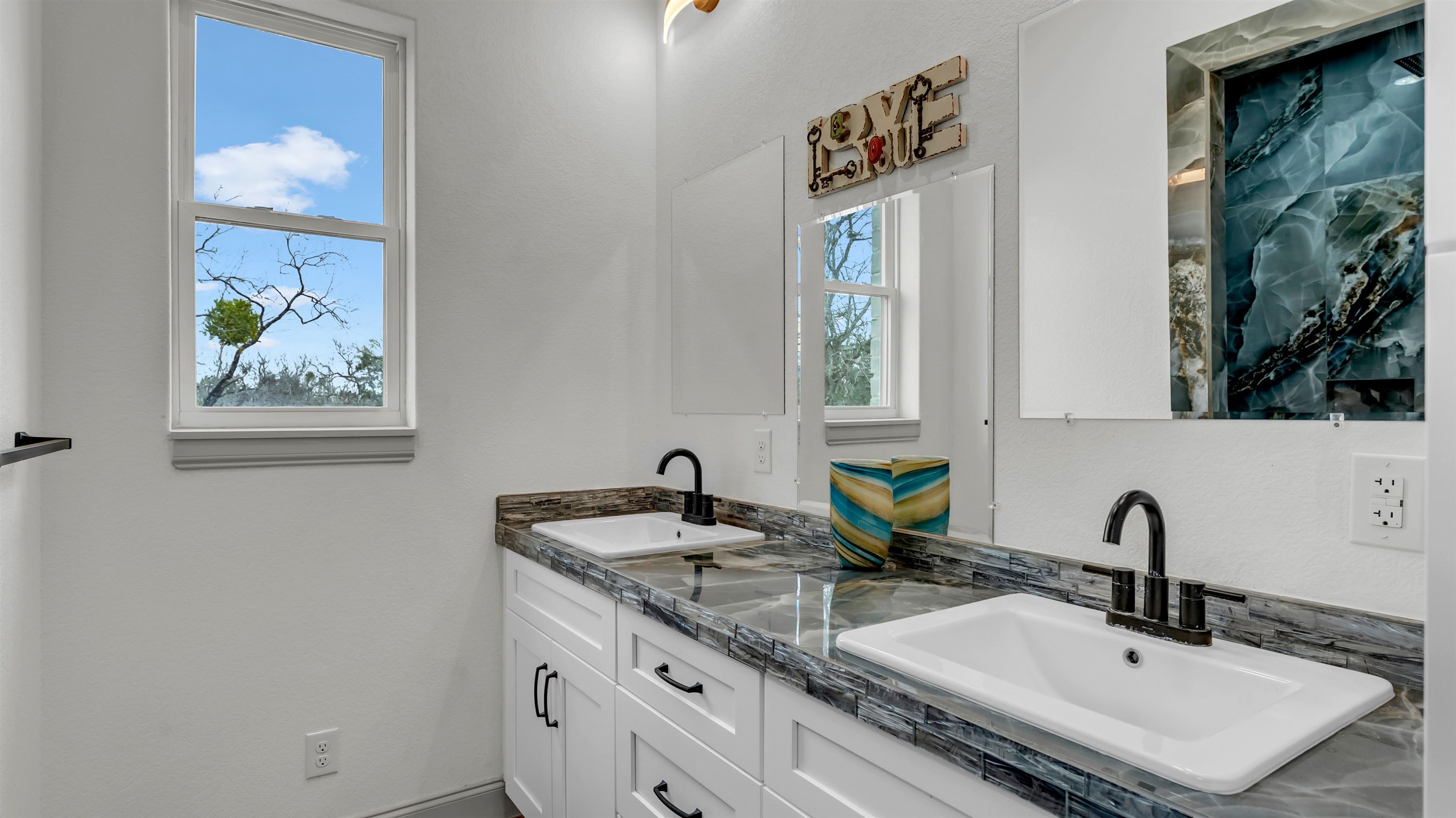 292 Oak Ridge Trail Kingsland, TX 78639 - Photo 19 of 29 a bathroom with a granite countertop sink and a mirror