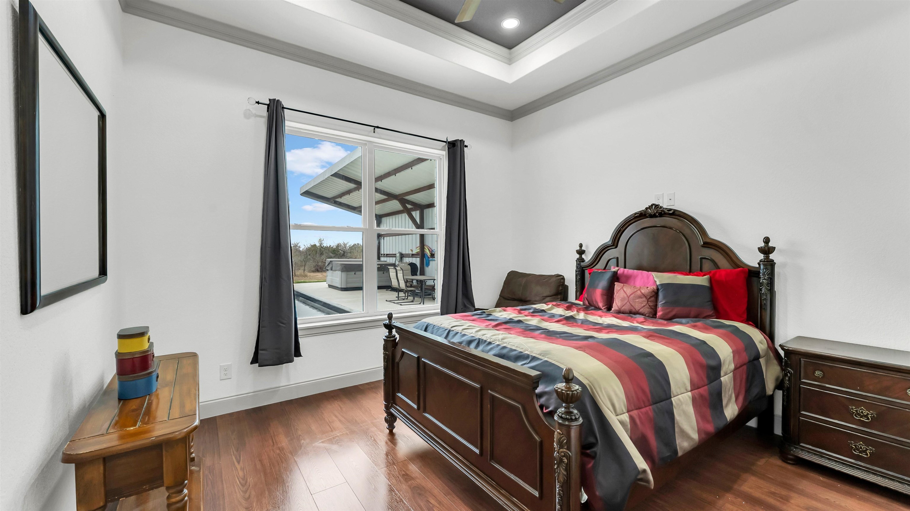 292 Oak Ridge Trail Kingsland, TX 78639 - Photo 22 of 29 a bedroom with a bed and wooden floor