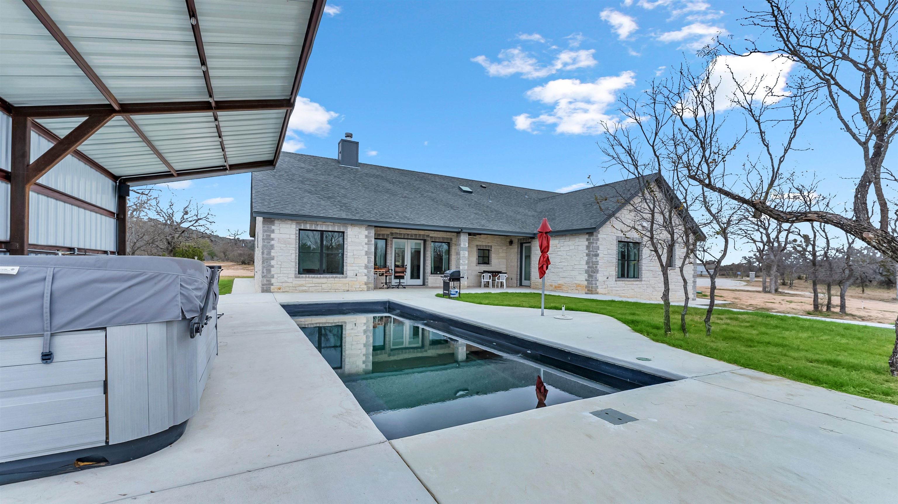 292 Oak Ridge Trail Kingsland, TX 78639 - Photo 26 of 29 a house view with a swimming pool and wooden stairs
