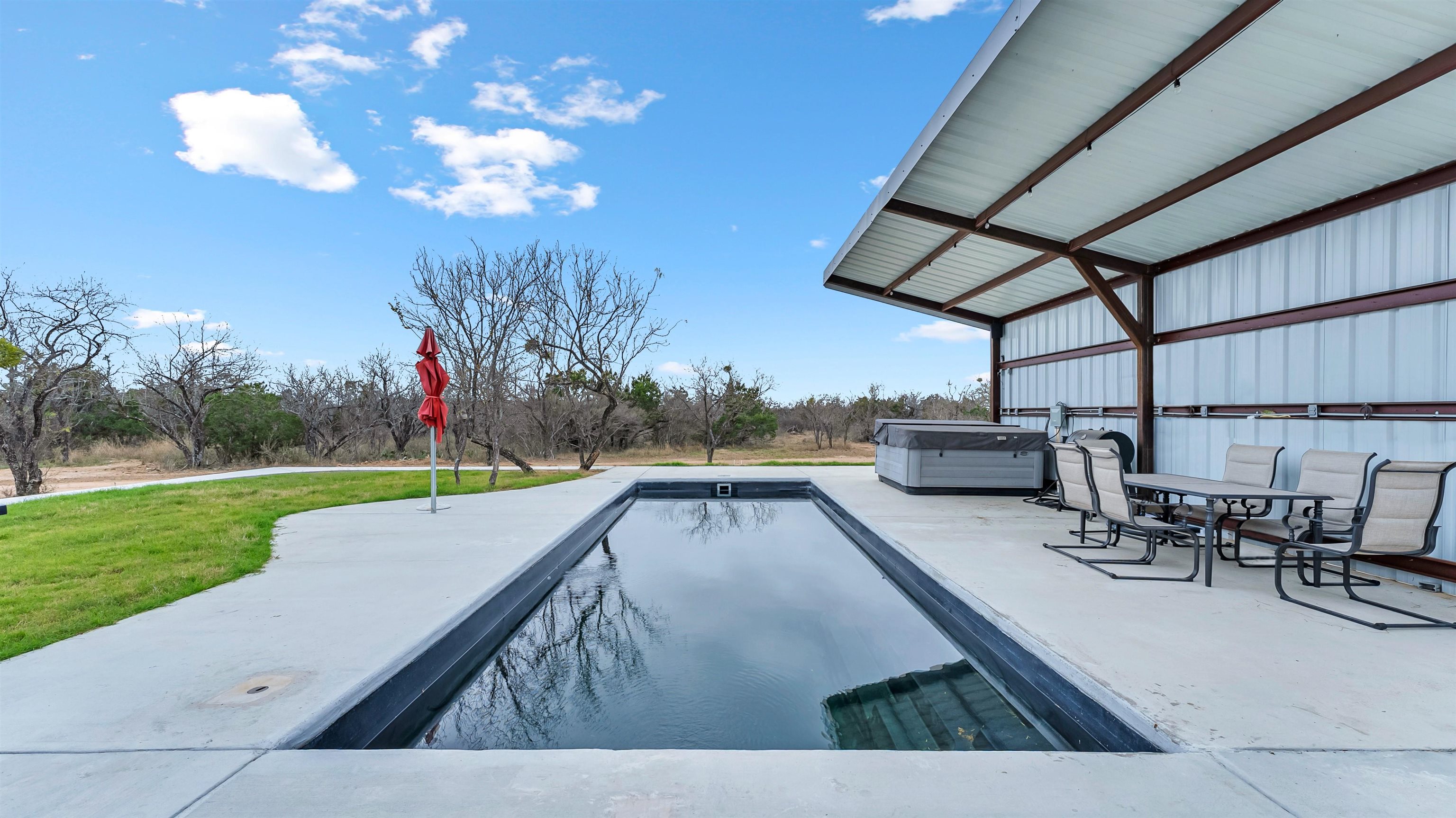 292 Oak Ridge Trail Kingsland, TX 78639 - Photo 27 of 29 a view of a swimming pool with a patio and a yard