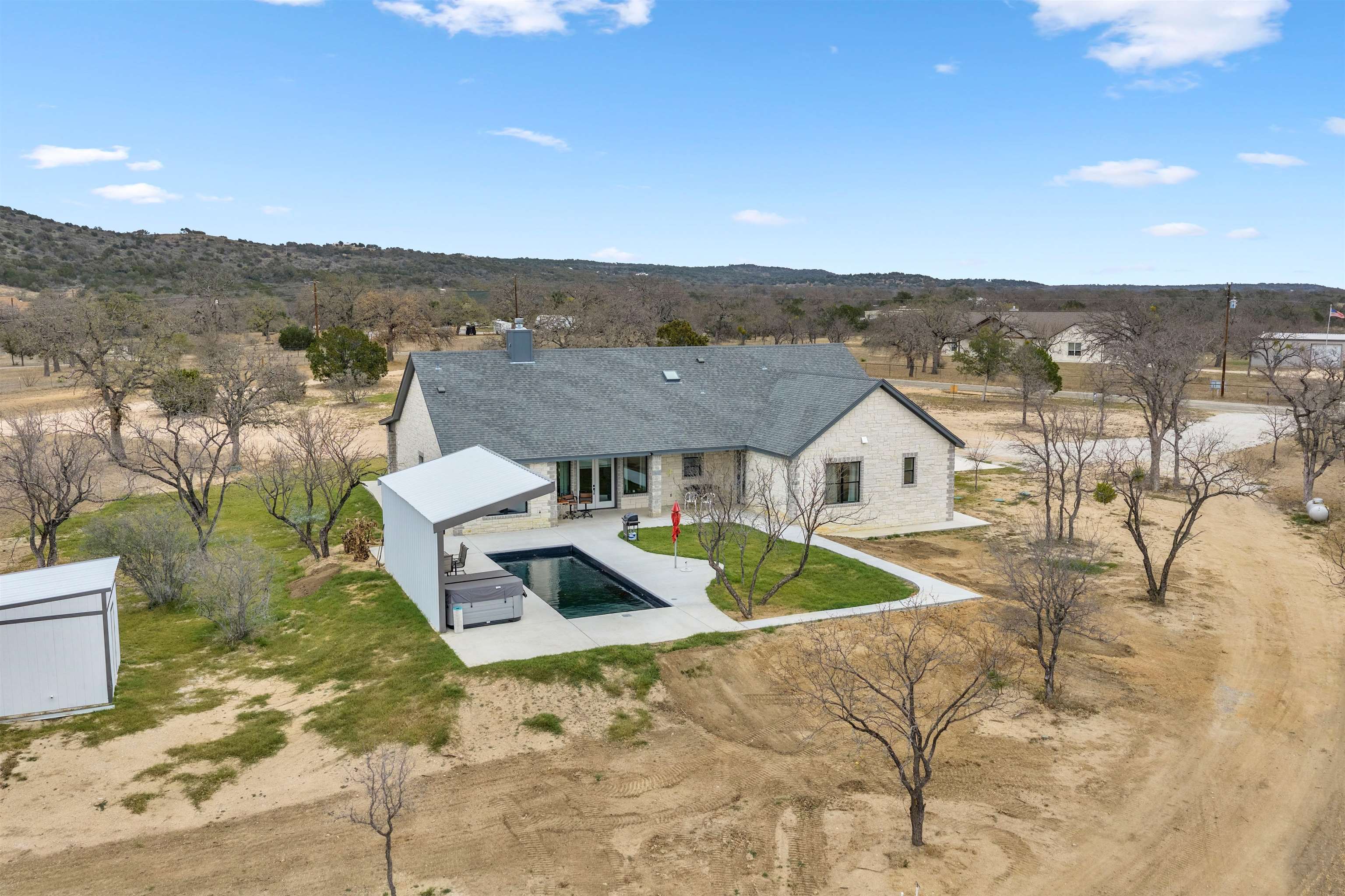 292 Oak Ridge Trail Kingsland, TX 78639 - Photo 28 of 29 an aerial view of residential houses with outdoor space and trees