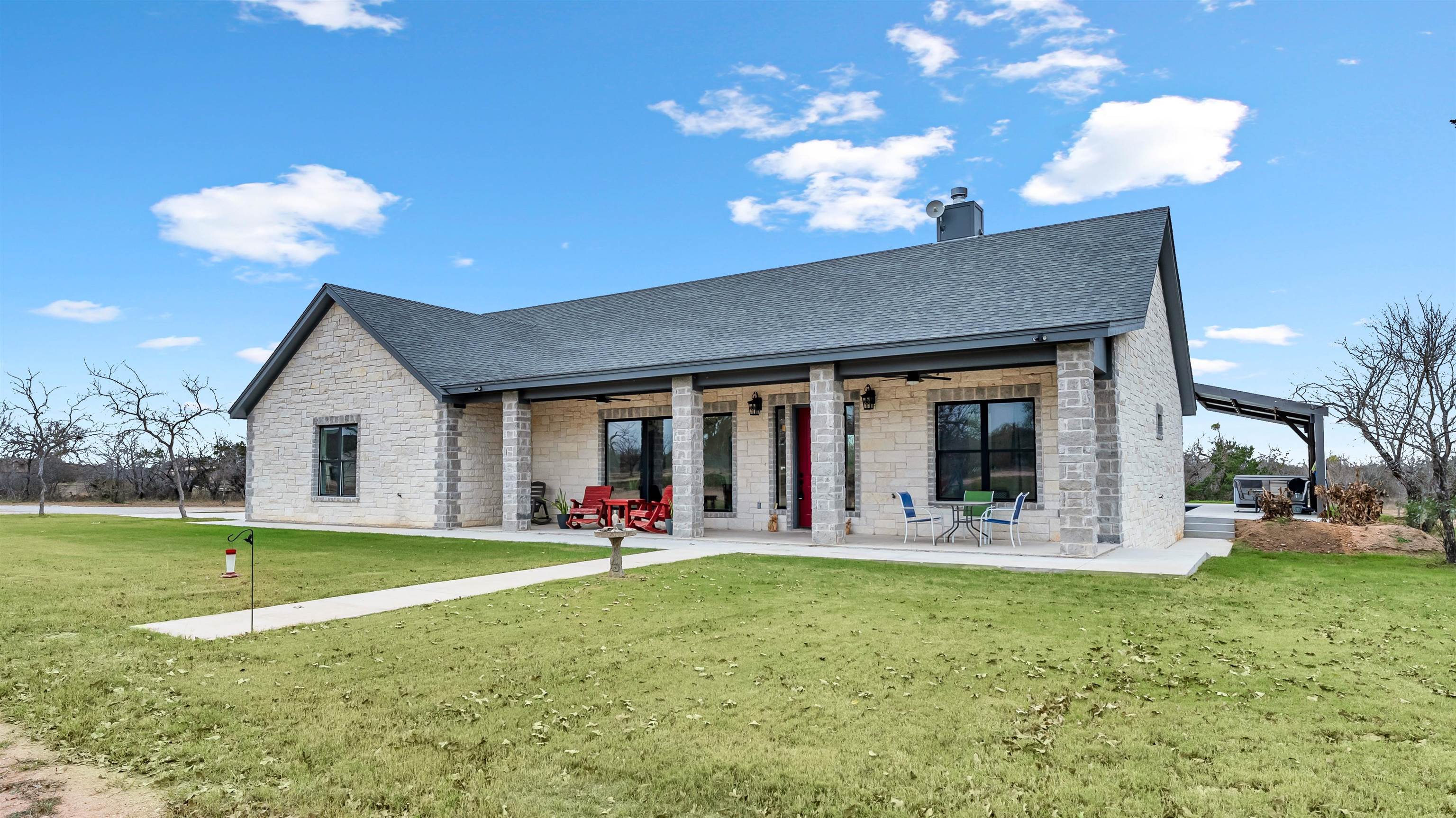 292 Oak Ridge Trail Kingsland, TX 78639 - Photo 4 of 29 a view of a house with backyard porch and sitting area