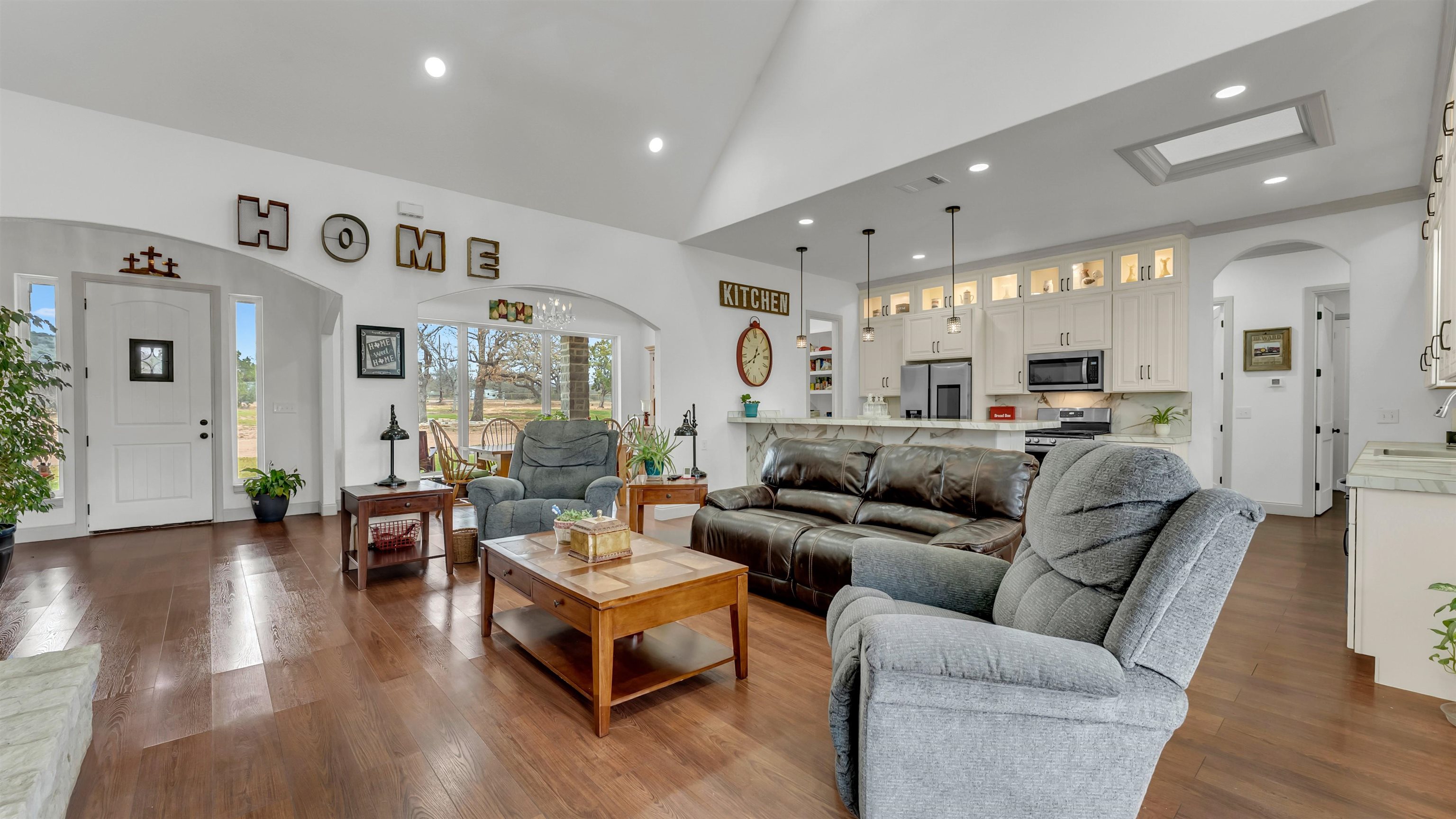 292 Oak Ridge Trail Kingsland, TX 78639 - Photo 7 of 29 a living room with furniture kitchen view and a wooden floor