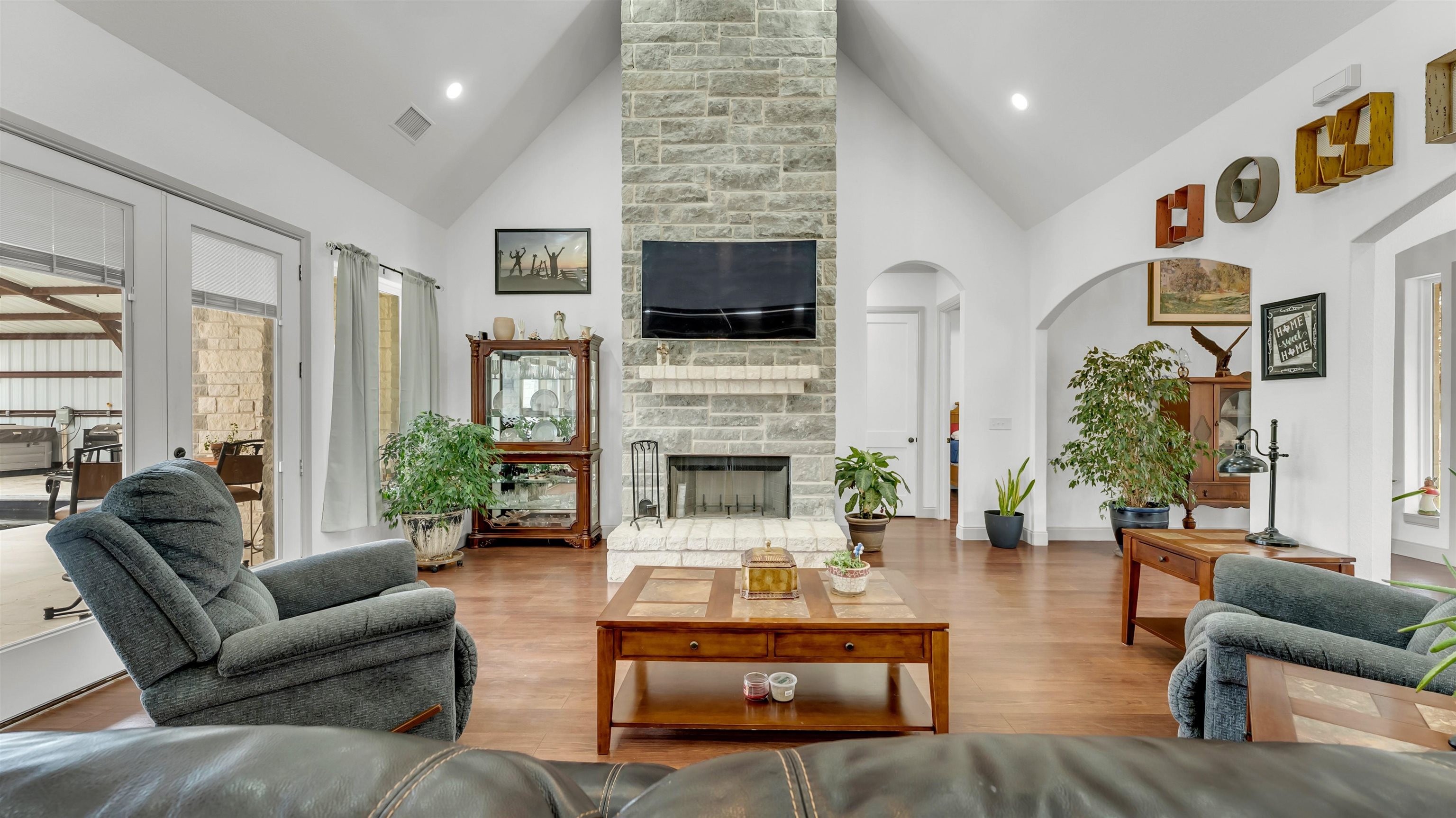 292 Oak Ridge Trail Kingsland, TX 78639 - Photo 8 of 29 a living room with furniture a flat screen tv and a fireplace