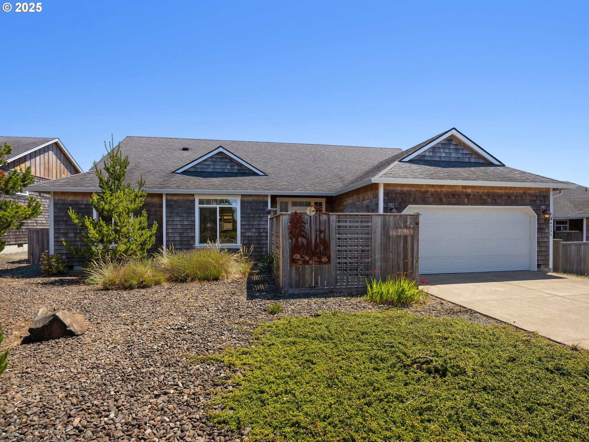 a front view of a house with a garden