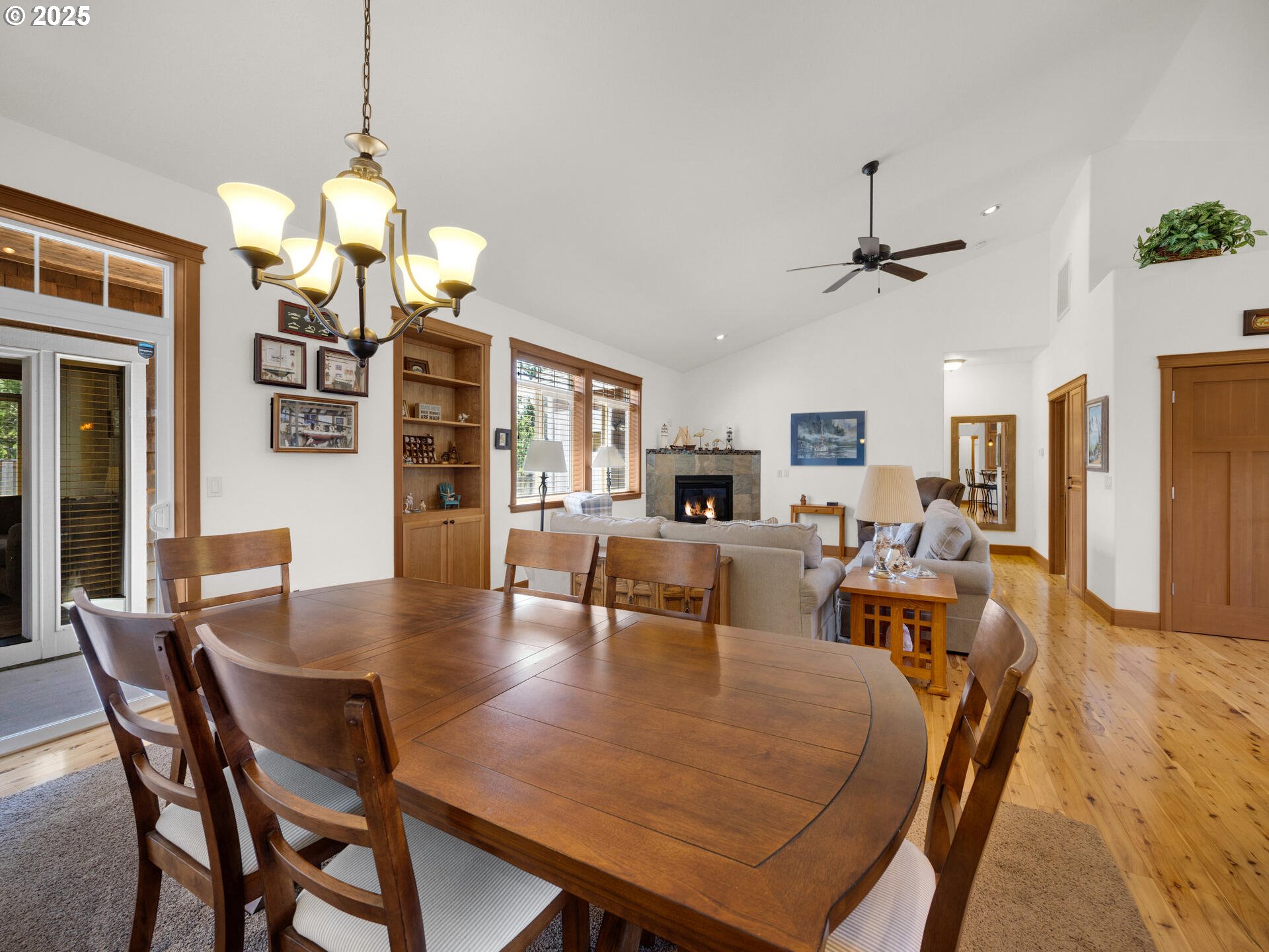 34535 Pinyon Drive Nehalem, OR 97131 - Photo 12 of 41 a view of a dining room and livingroom with furniture wooden floor a chandelier