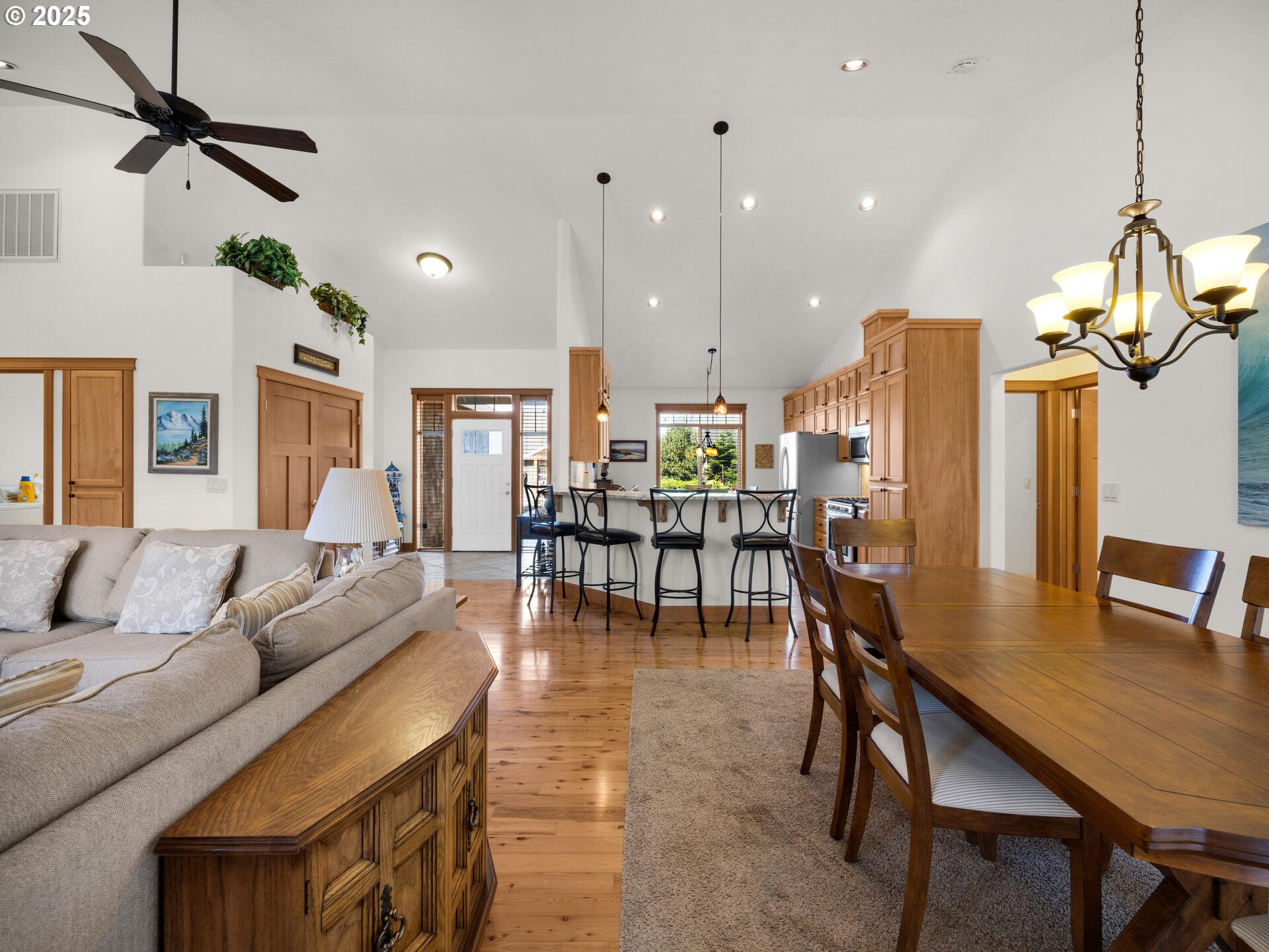 34535 Pinyon Drive Nehalem, OR 97131 - Photo 13 of 41 a living room with furniture kitchen view and a chandelier