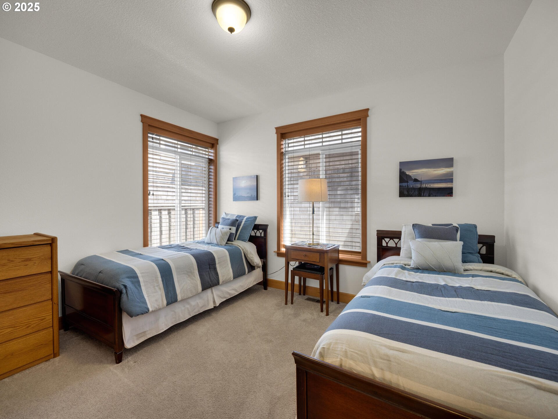 34535 Pinyon Drive Nehalem, OR 97131 - Photo 22 of 41 a spacious bedroom with a bed and lamp