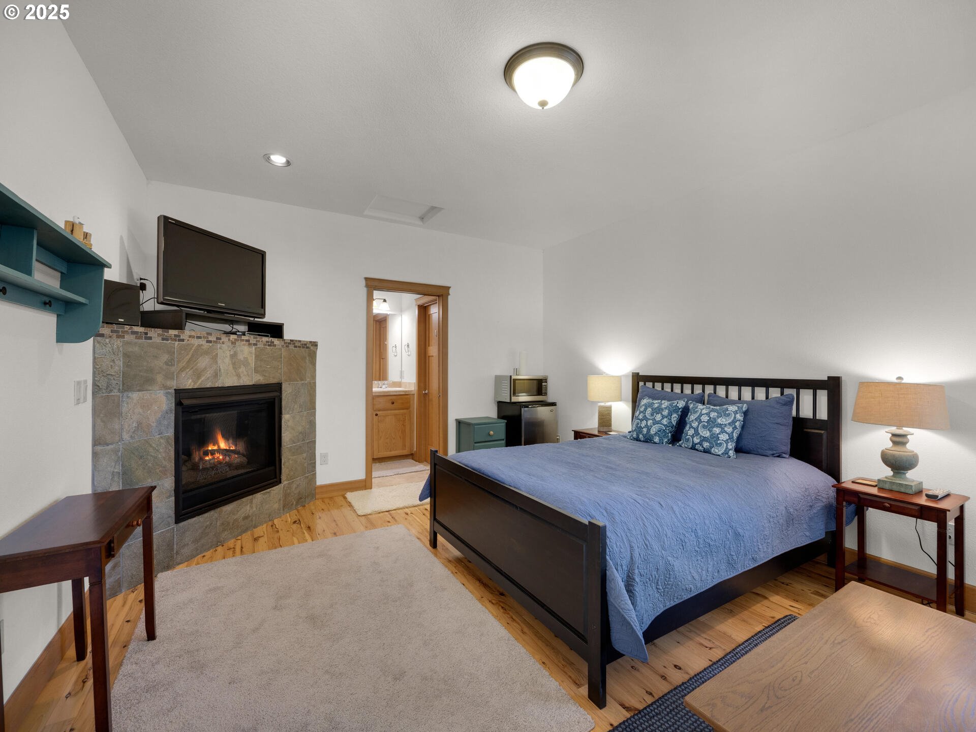 34535 Pinyon Drive Nehalem, OR 97131 - Photo 24 of 41 a bedroom with a bed and a fireplace