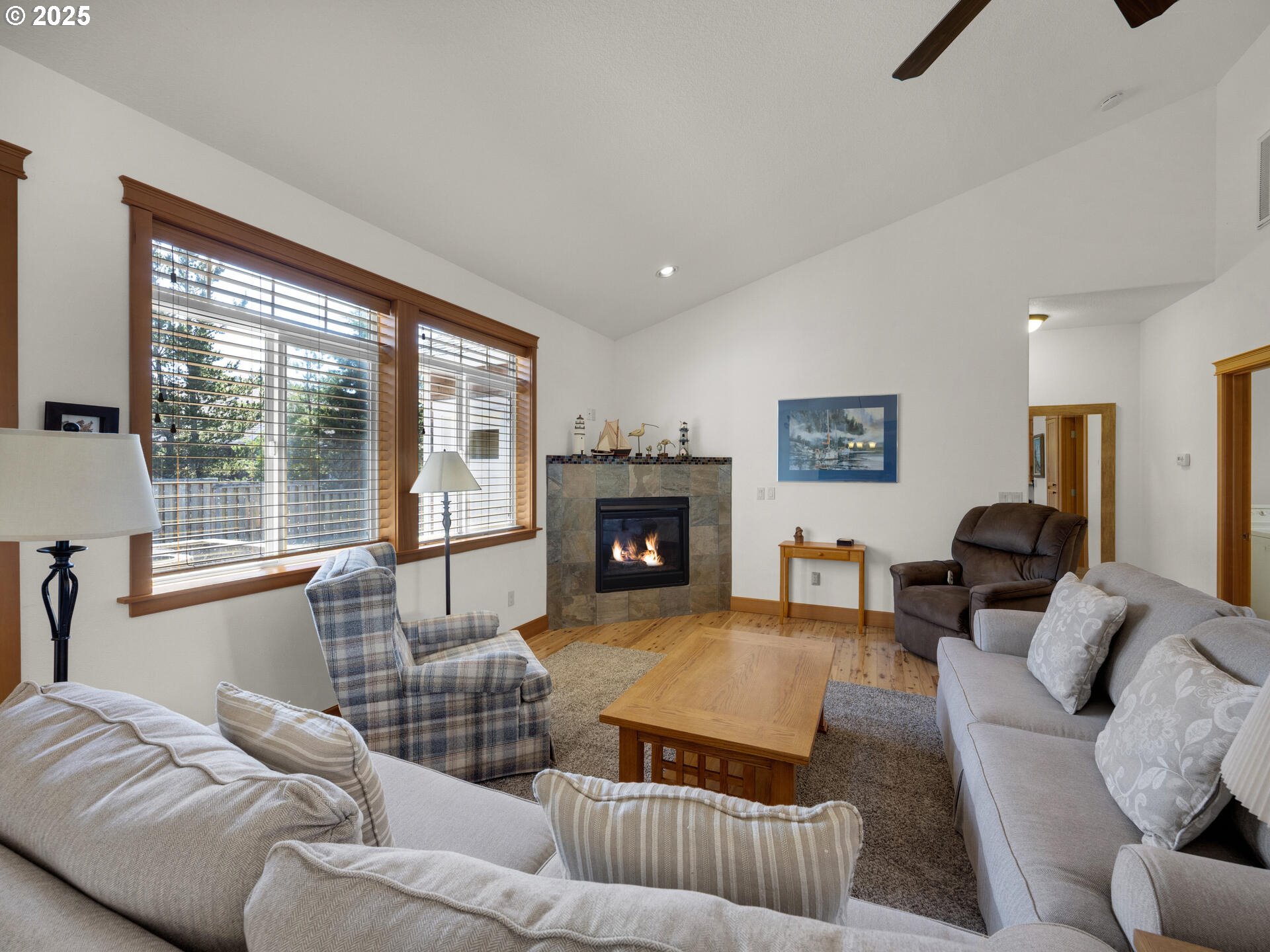 34535 Pinyon Drive Nehalem, OR 97131 - Photo 9 of 41 a living room with furniture large window and a fireplace