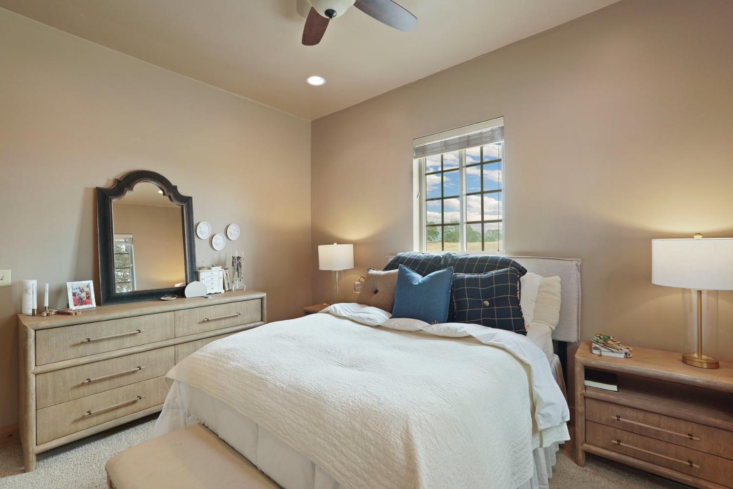 21754 North Cord Road Clements, CA 95227 - Photo 23 of 60 a bedroom with a bed and a dresser with mirror