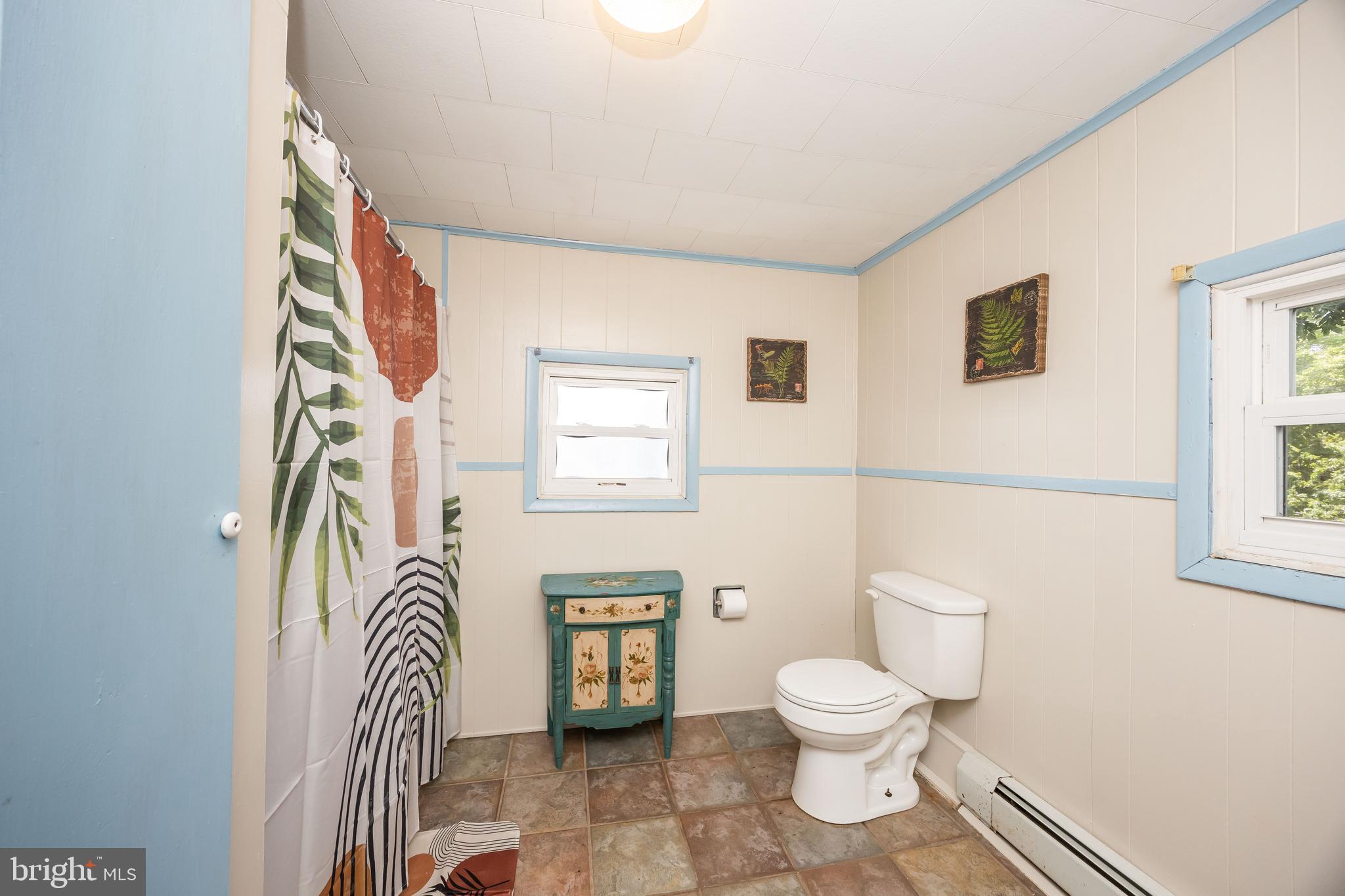 26467 Mariners Road Crisfield, MD 21817 - Photo 35 of 44 a bathroom with a toilet a sink and a mirror