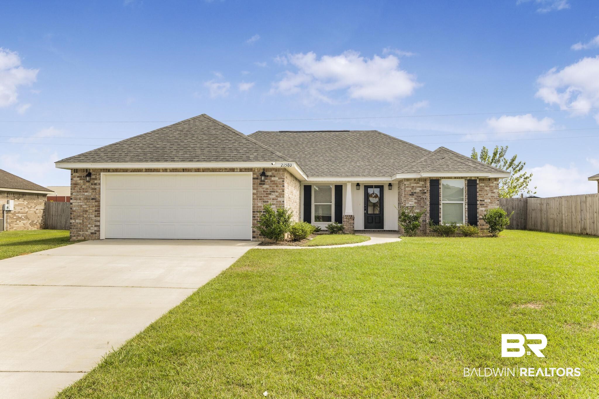21580 Talbot Lane Robertsdale, AL 36567 - Photo 1 of 25 Single story home with roof with shingles, brick siding, concrete driveway, a garage, and a porch