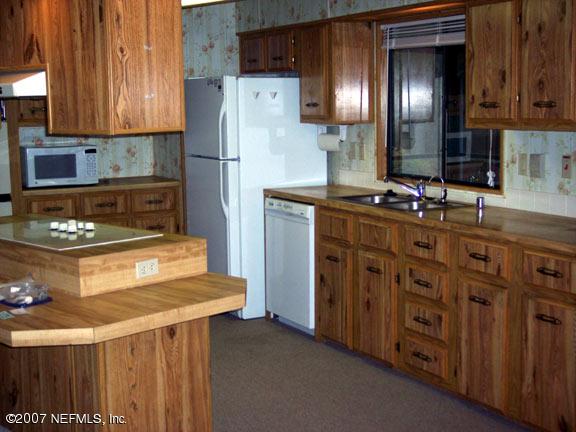 110 Bayberry Road Georgetown, FL 32139 - Photo 11 of 17 a kitchen with stainless steel appliances granite countertop a stove a refrigerator and a stove