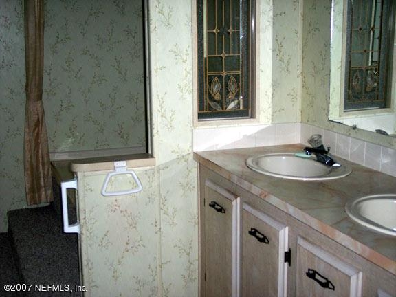 110 Bayberry Road Georgetown, FL 32139 - Photo 13 of 17 a bathroom with a sink and a mirror